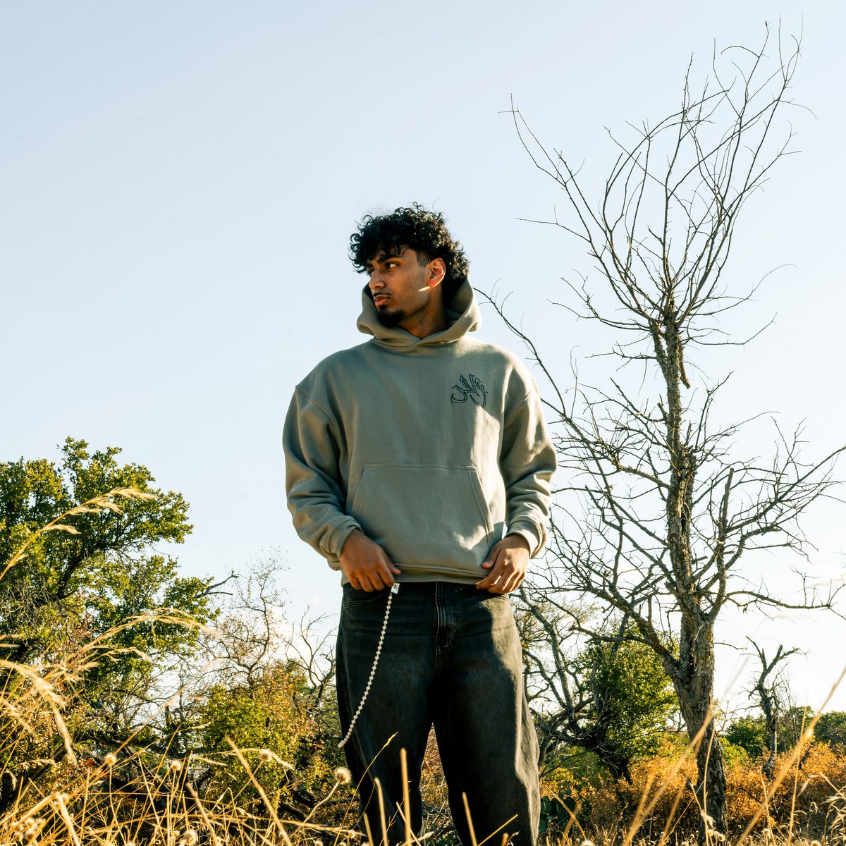 Wahid Gray Hoodie, Gray colorway — model wearing the hoodie outdoors, front graphic visible