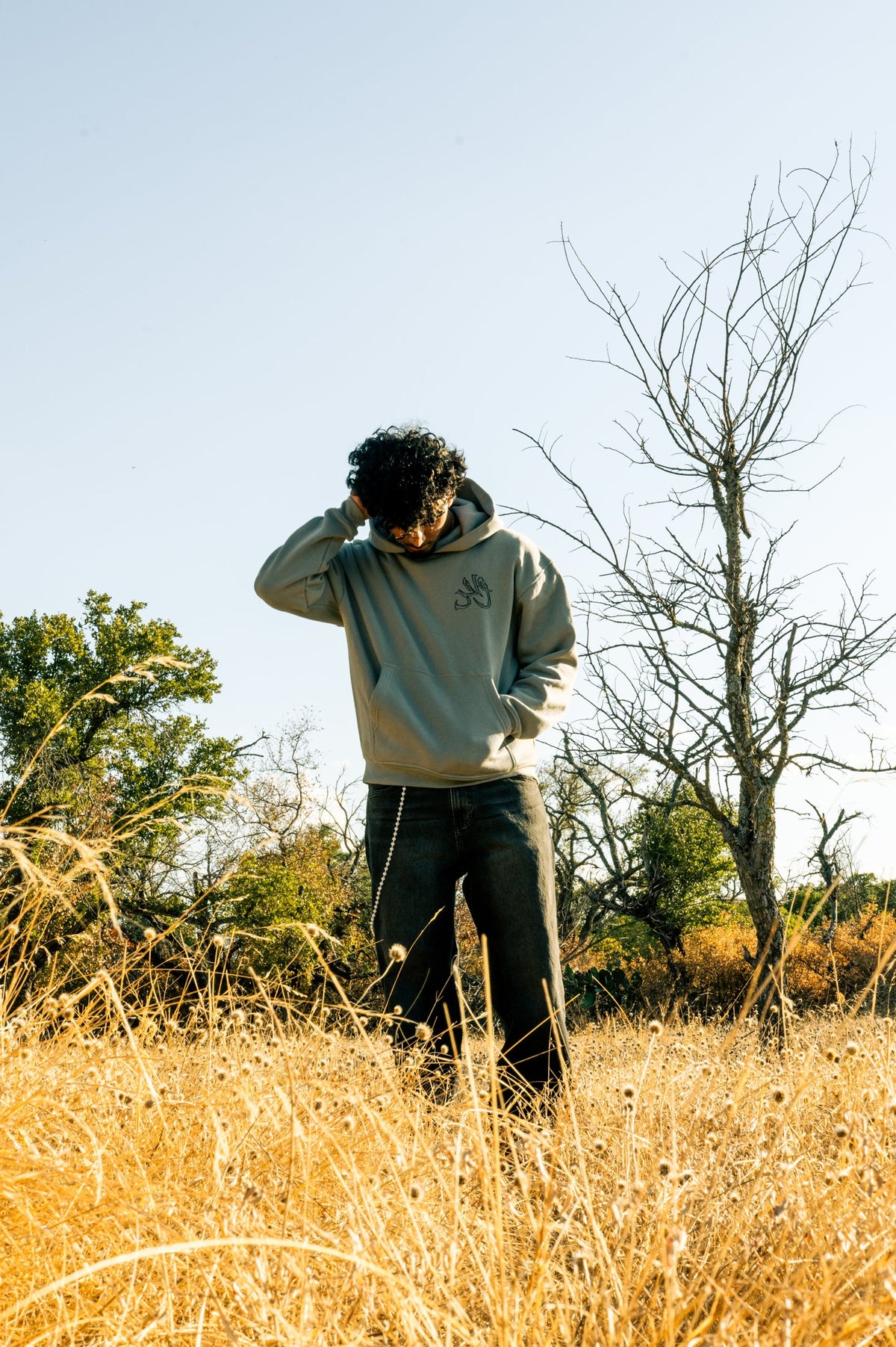 Model wearing the gray Wahid hoodie outdoors